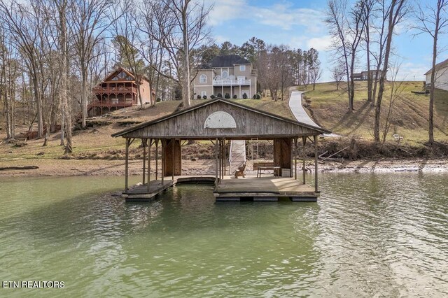 view of dock with a water view and a gazebo