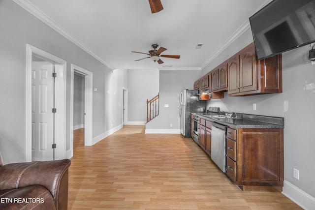 kitchen featuring dark countertops, light wood-style flooring, stainless steel appliances, and exhaust hood