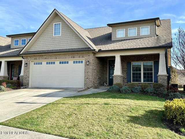 craftsman-style house featuring a front lawn and a garage