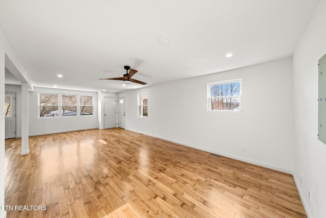 unfurnished living room featuring light wood-style flooring, baseboards, ceiling fan, and recessed lighting