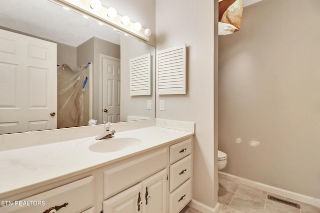 full bathroom with visible vents, toilet, vanity, baseboards, and walk in shower