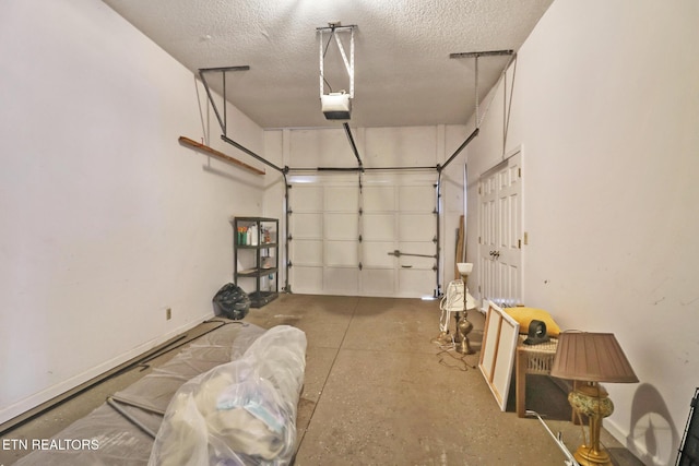 garage featuring a garage door opener and baseboards