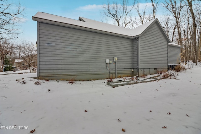 view of snow covered exterior with crawl space