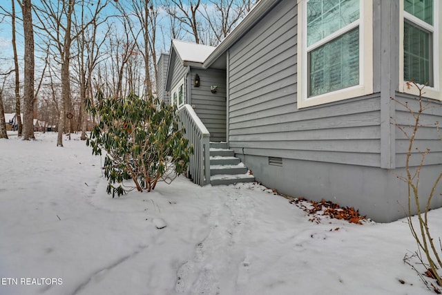 view of snowy exterior featuring crawl space