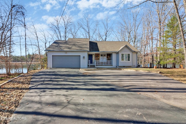 view of front of house featuring aphalt driveway, roof with shingles, a porch, and an attached garage