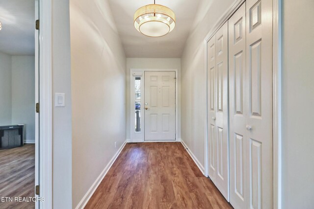 entryway with baseboards and wood finished floors