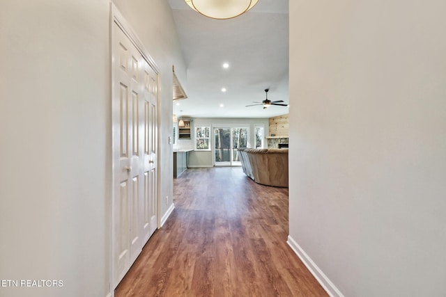 corridor featuring recessed lighting, baseboards, and wood finished floors