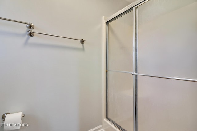 bathroom with a shower with shower door