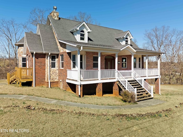 view of front facade featuring covered porch, brick siding, roof with shingles, and a chimney