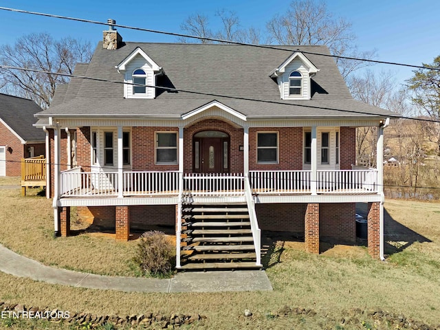 view of front of property with a porch, brick siding, stairs, roof with shingles, and a front yard