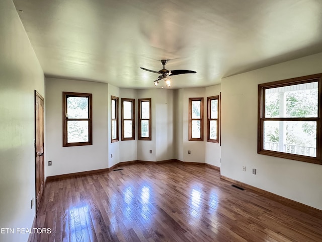 1998 Tranquility Ln, Sevierville, TN 37876 - empty room with plenty of natural light, wood finished floors, ceiling fan, and baseboards