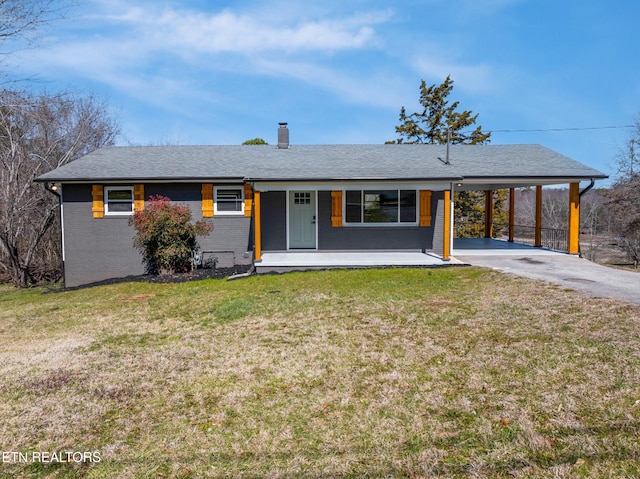 single story home featuring brick siding, covered porch, an attached carport, driveway, and a front lawn