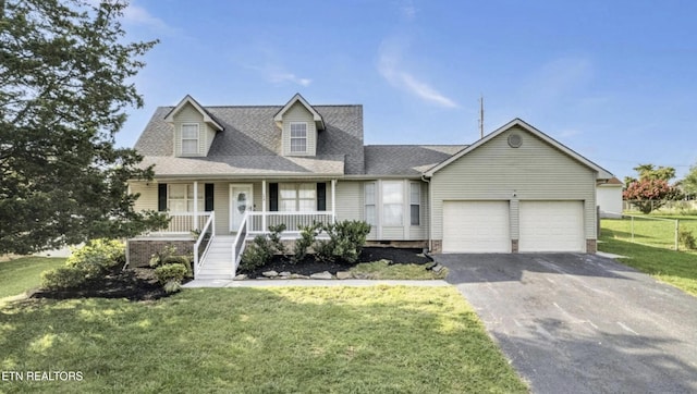 cape cod-style house featuring a garage, covered porch, and a front yard