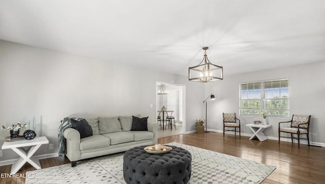 living room with a chandelier and light hardwood / wood-style floors