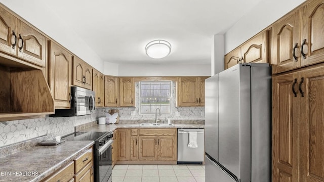 kitchen featuring sink, appliances with stainless steel finishes, tasteful backsplash, and light tile patterned floors