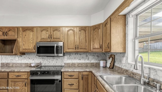 kitchen featuring appliances with stainless steel finishes, sink, and tasteful backsplash