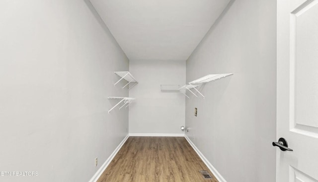 spacious closet featuring hardwood / wood-style floors