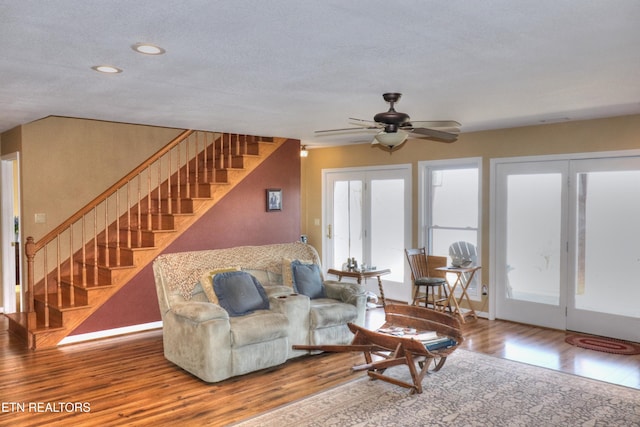 living room with ceiling fan, stairway, wood finished floors, and recessed lighting