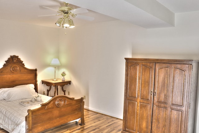 bedroom with wood finished floors, a ceiling fan, and baseboards