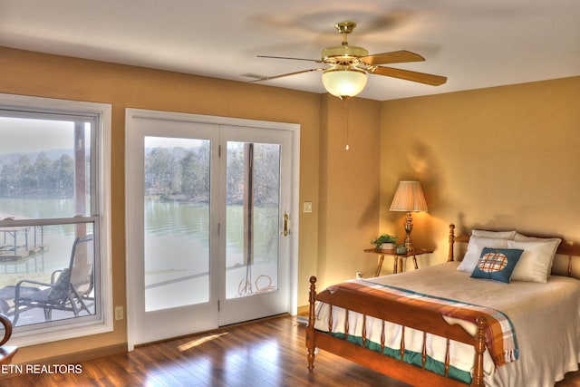 bedroom with access to outside, visible vents, ceiling fan, and dark wood-style flooring