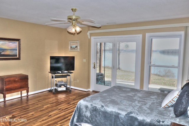 bedroom featuring access to outside, dark wood-type flooring, a ceiling fan, and baseboards