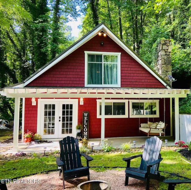 back of property with french doors and a chimney