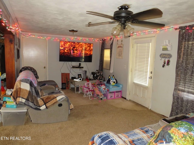 rec room with ceiling fan and carpet flooring