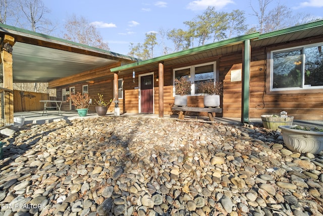 view of front of house featuring a patio area and fence