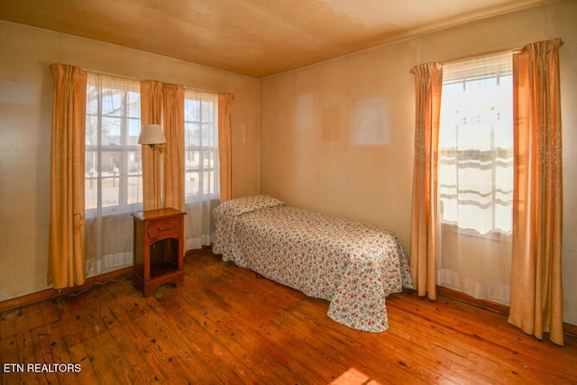 bedroom with hardwood / wood-style flooring