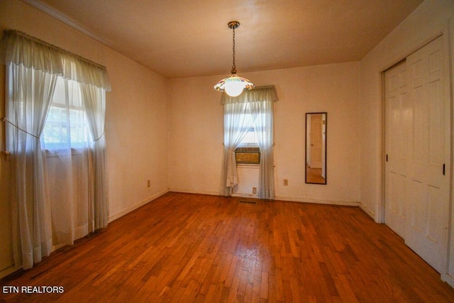 interior space with baseboards and hardwood / wood-style floors