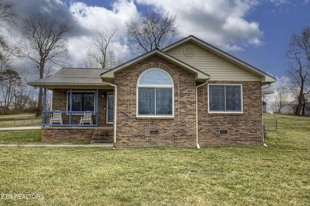 view of front of home featuring brick siding, covered porch, a front yard, and crawl space