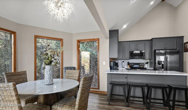 3809 Ravens Den Way, Sevierville, TN 37862 - dining room with an inviting chandelier, baseboards, high vaulted ceiling, and dark wood finished floors