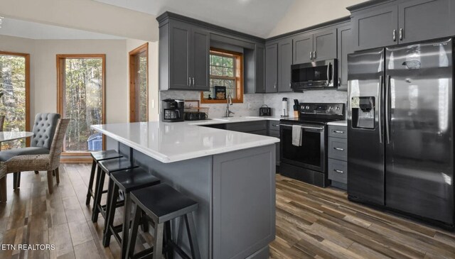 3809 Ravens Den Way, Sevierville, TN 37862 - kitchen with light countertops, appliances with stainless steel finishes, gray cabinets, and decorative backsplash