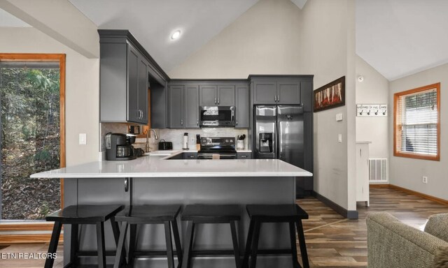 3809 Ravens Den Way, Sevierville, TN 37862 - kitchen featuring a peninsula, gray cabinets, stainless steel appliances, light countertops, and a sink