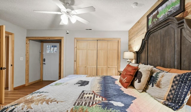 3809 Ravens Den Way, Sevierville, TN 37862 - bedroom featuring visible vents, baseboards, ceiling fan, a textured ceiling, and wood walls
