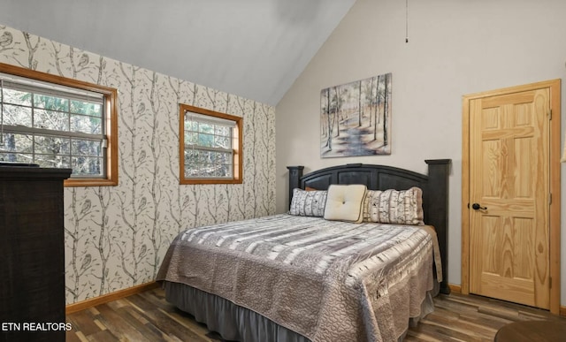 3809 Ravens Den Way, Sevierville, TN 37862 - bedroom with wallpapered walls, baseboards, vaulted ceiling, and dark wood-style flooring