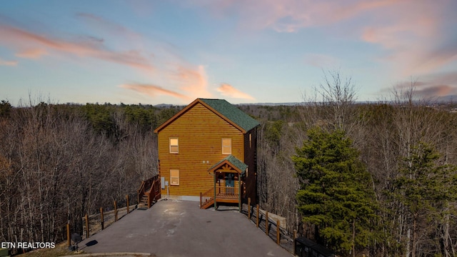 exterior space with a wooded view