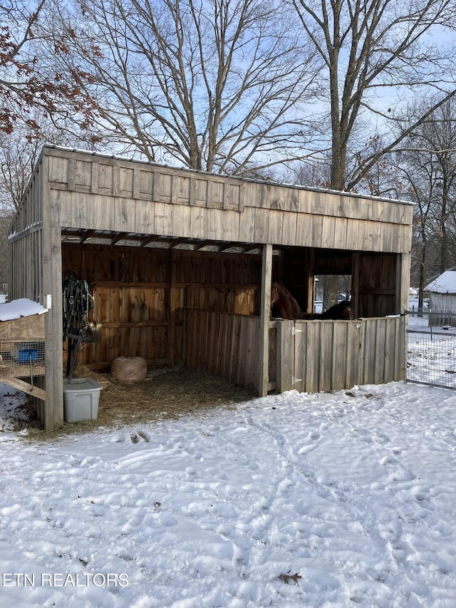 snow covered structure featuring an outdoor structure