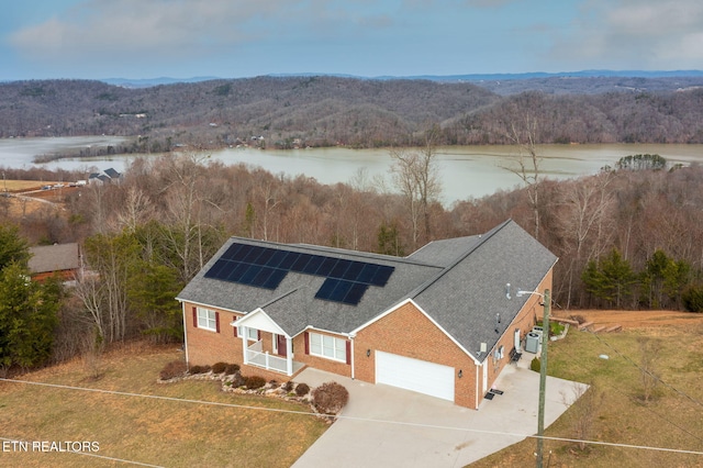 aerial view with a water view and a view of trees