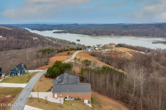 bird's eye view with a forest view and a water and mountain view