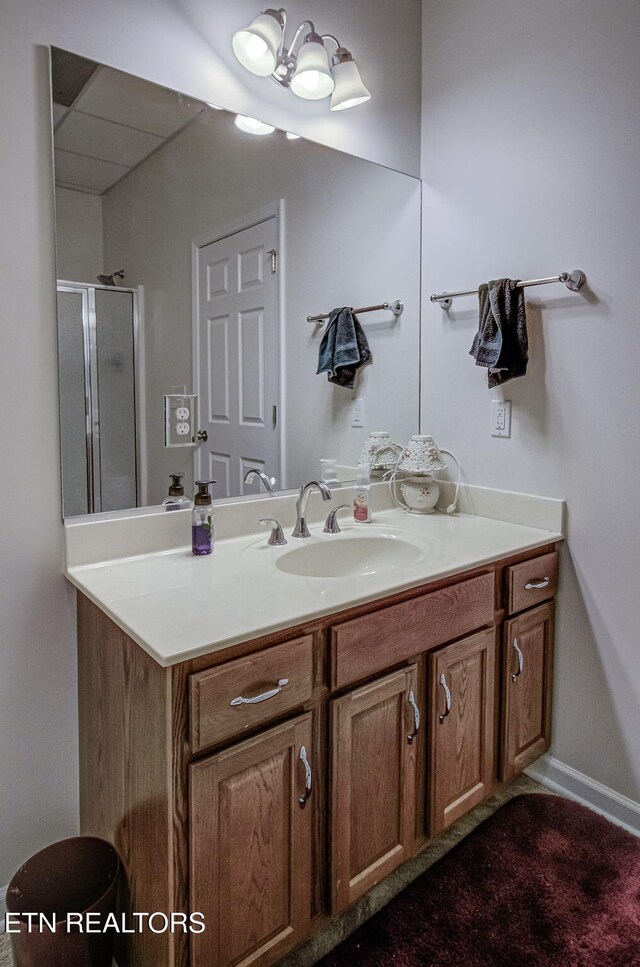 full bathroom featuring a shower stall, vanity, and baseboards