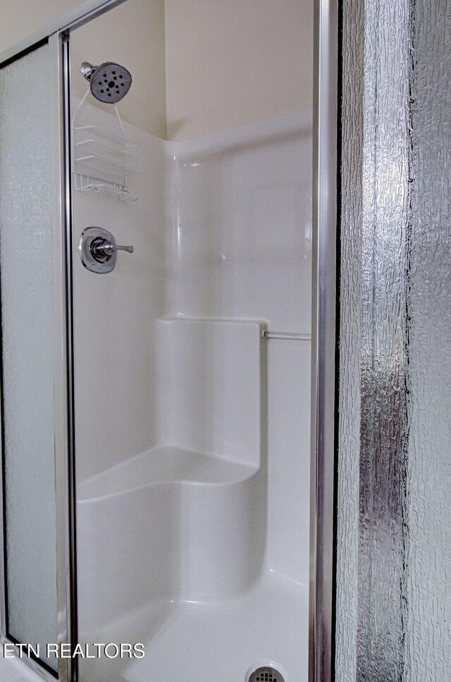 full bathroom featuring a stall shower