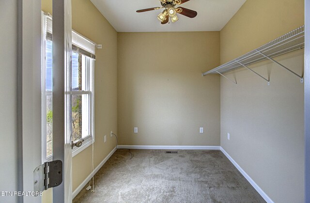 carpeted spare room with baseboards, ceiling fan, plenty of natural light, and a water view