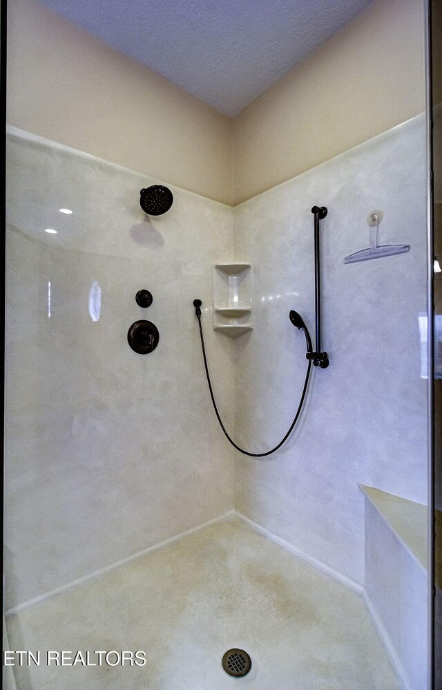 full bath featuring a tile shower