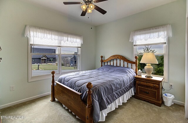 bedroom with carpet floors, baseboards, and a ceiling fan