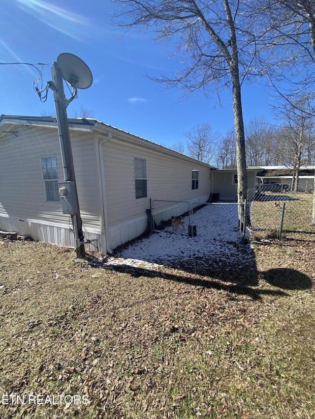 view of home's exterior with fence