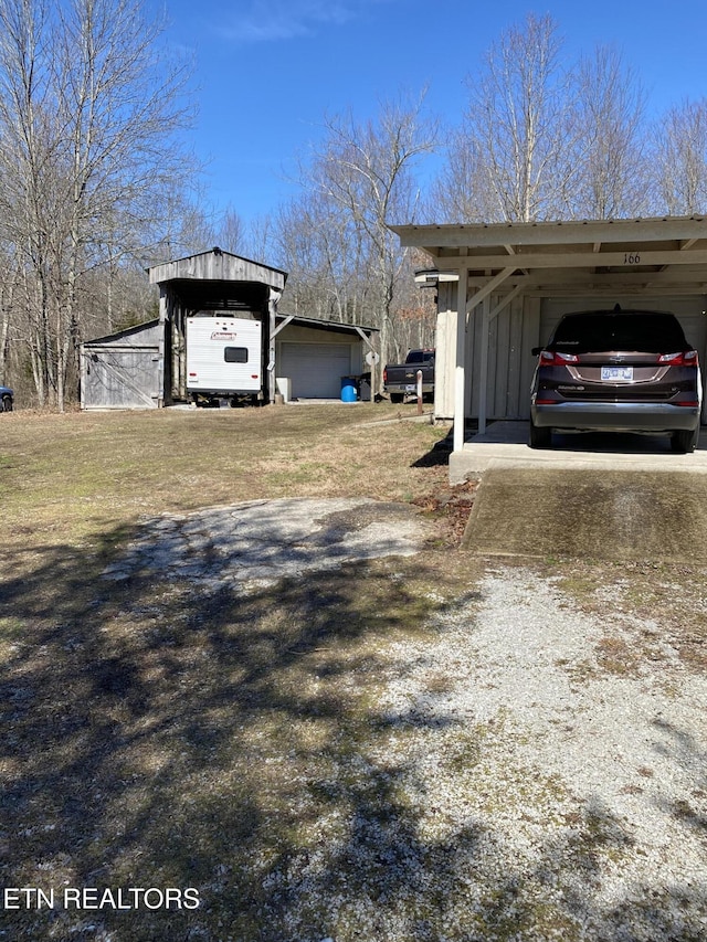 view of yard with a carport and driveway