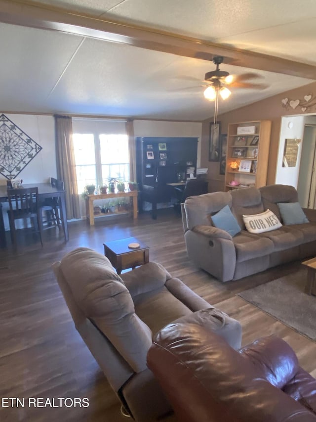 living area featuring lofted ceiling with beams, ceiling fan, and wood finished floors