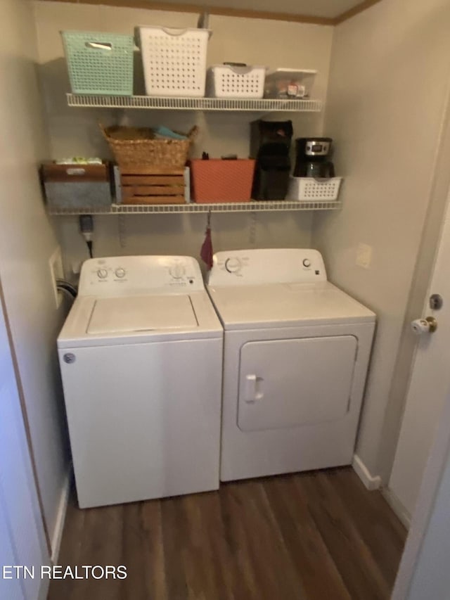 clothes washing area featuring laundry area, separate washer and dryer, dark wood-style flooring, and baseboards