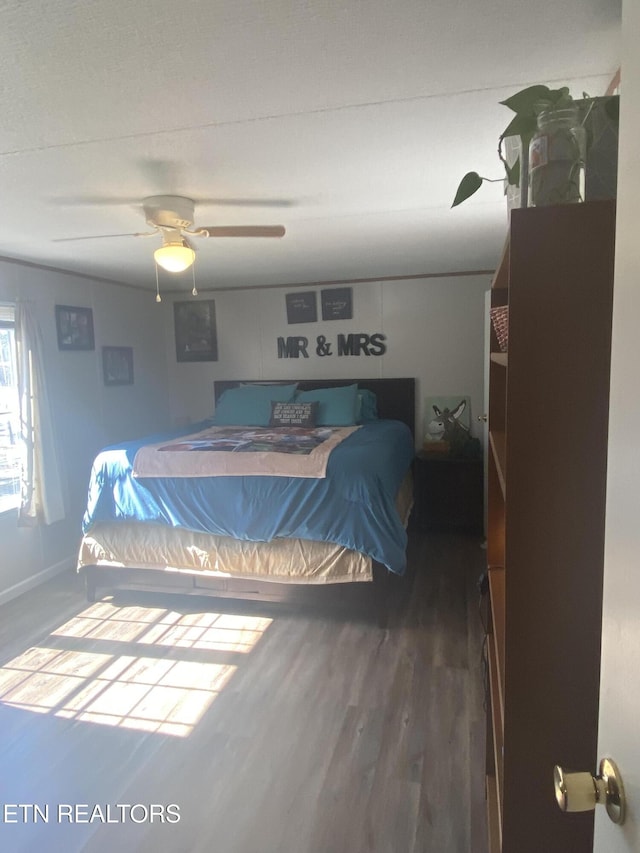 bedroom with dark wood-style flooring and ceiling fan